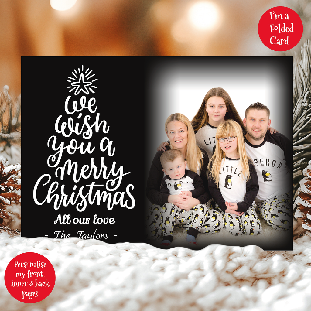 a family christmas card with a christmas tree in the background