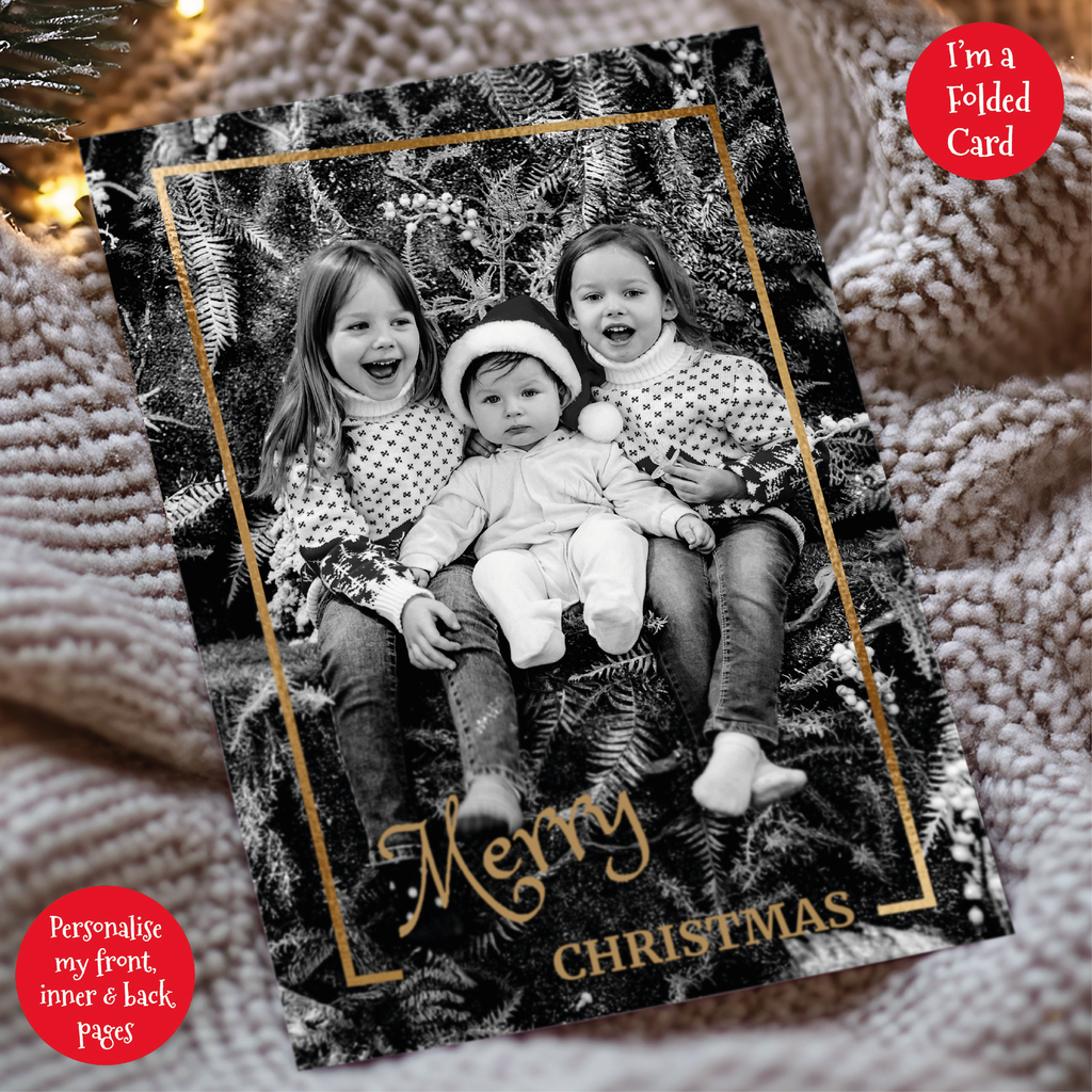 a christmas card with two children sitting on a blanket