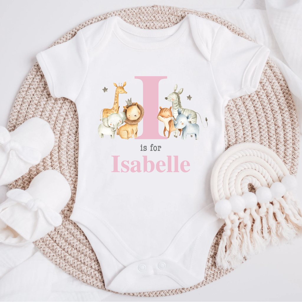 Personalised baby jungle safari animal vest in pink powder, featuring an initial and name' design with adorable illustrations of a giraffe, lion, fox, elephant and zebra on a white bodysuit. Perfect for newborns to 12 months.